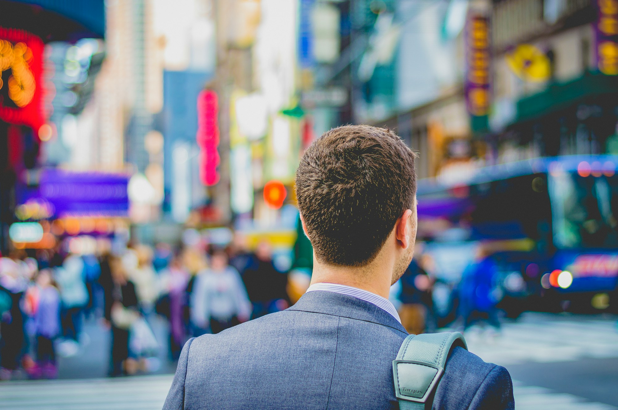 man in suit on city sidewalk